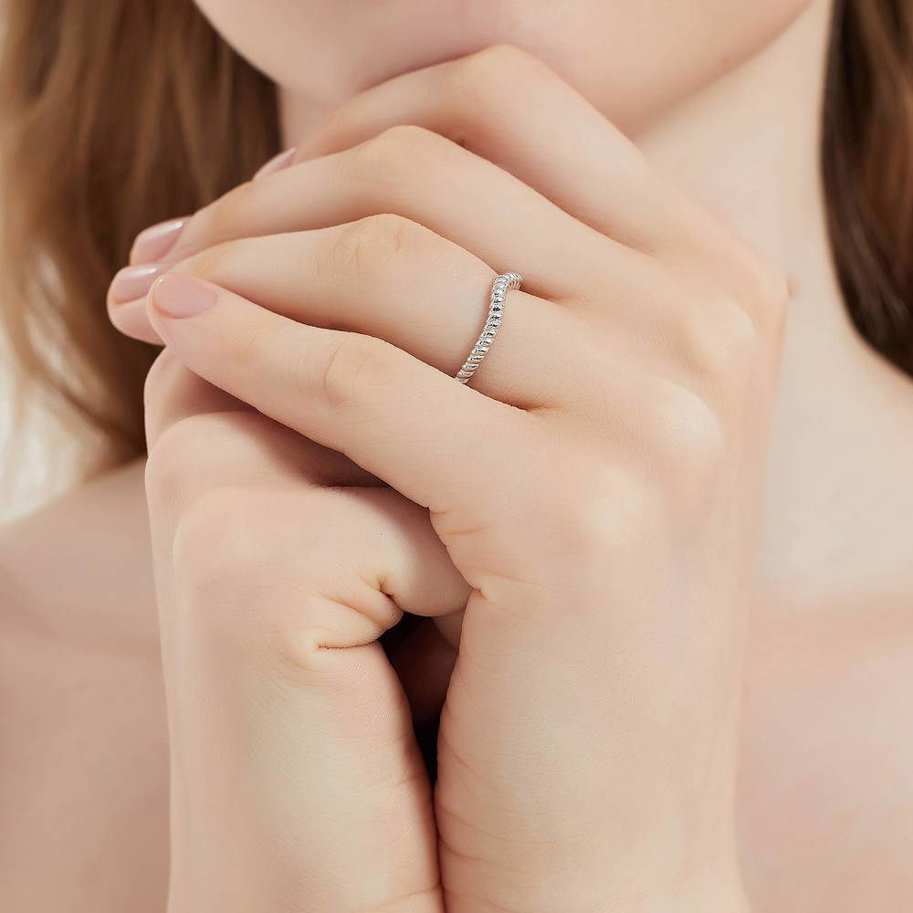 Model wearing 3-Stone Woven Princess CZ Ring Set in Sterling Silver