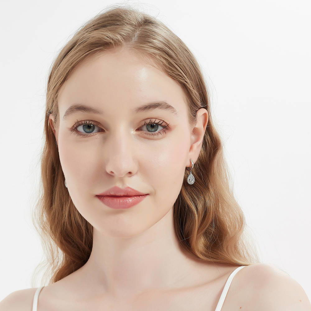 Model wearing Halo Pear CZ Dangle Earrings in Sterling Silver