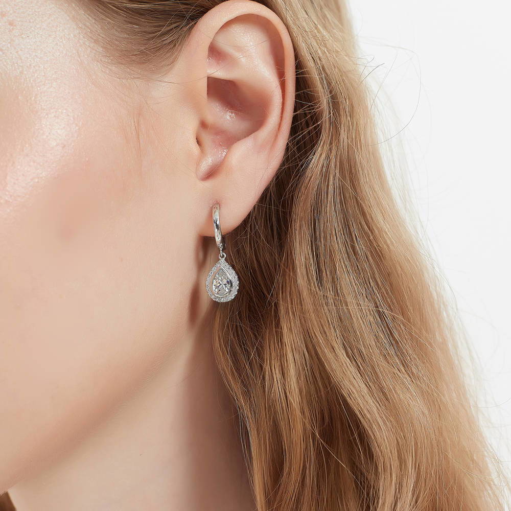 Model wearing Halo Pear CZ Dangle Earrings in Sterling Silver