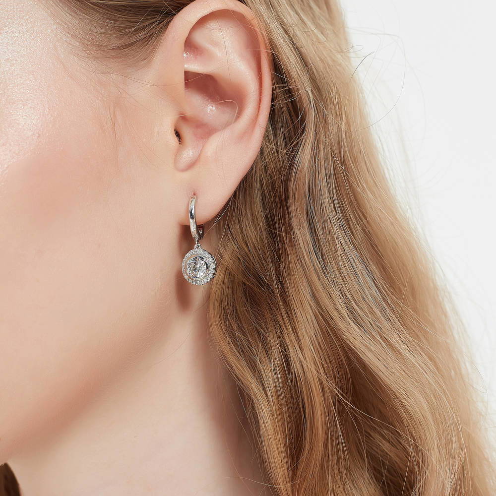 Model wearing Halo Round CZ Dangle Earrings in Sterling Silver