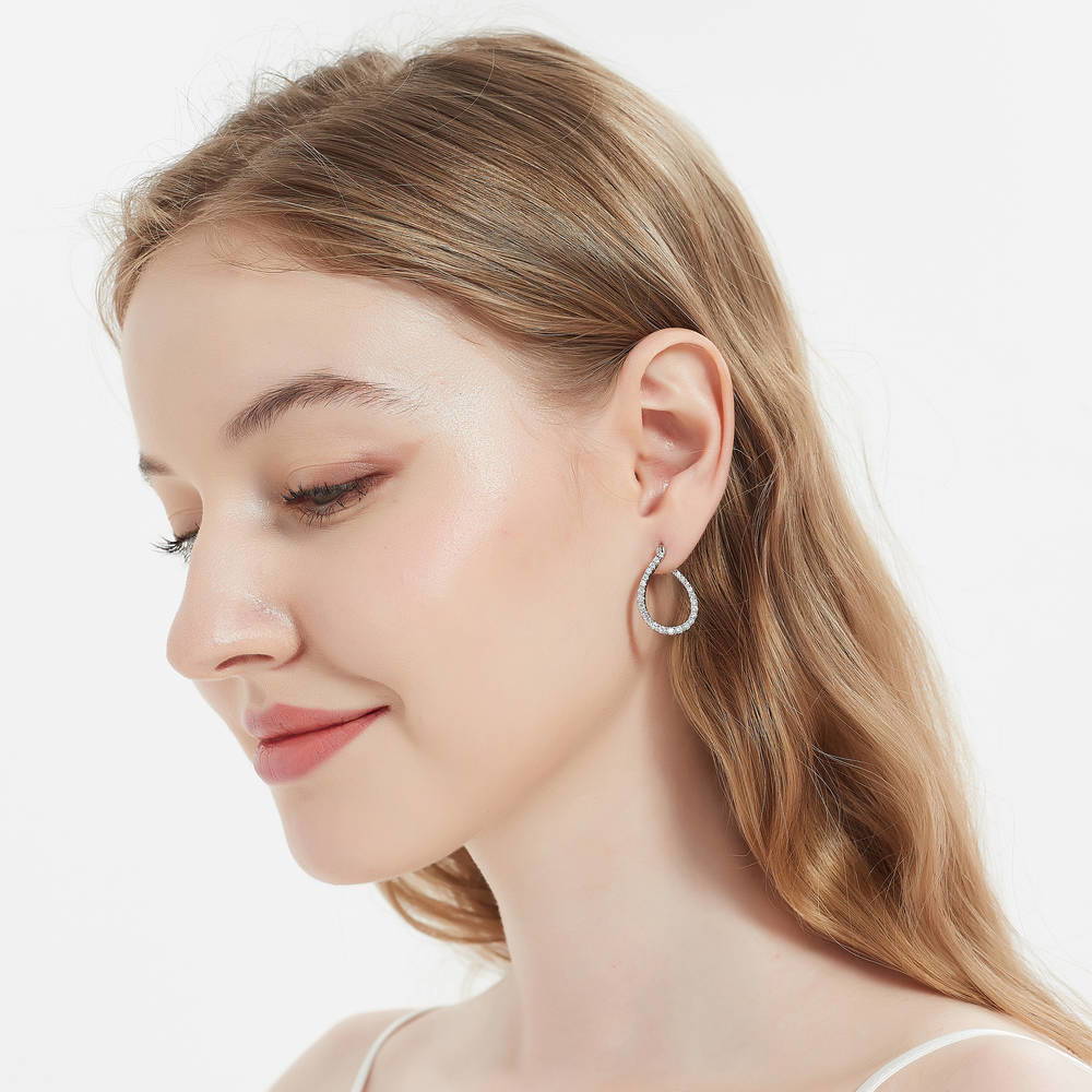 Model wearing Teardrop Woven CZ Medium Hoop Earrings in Sterling Silver 0.98 inch