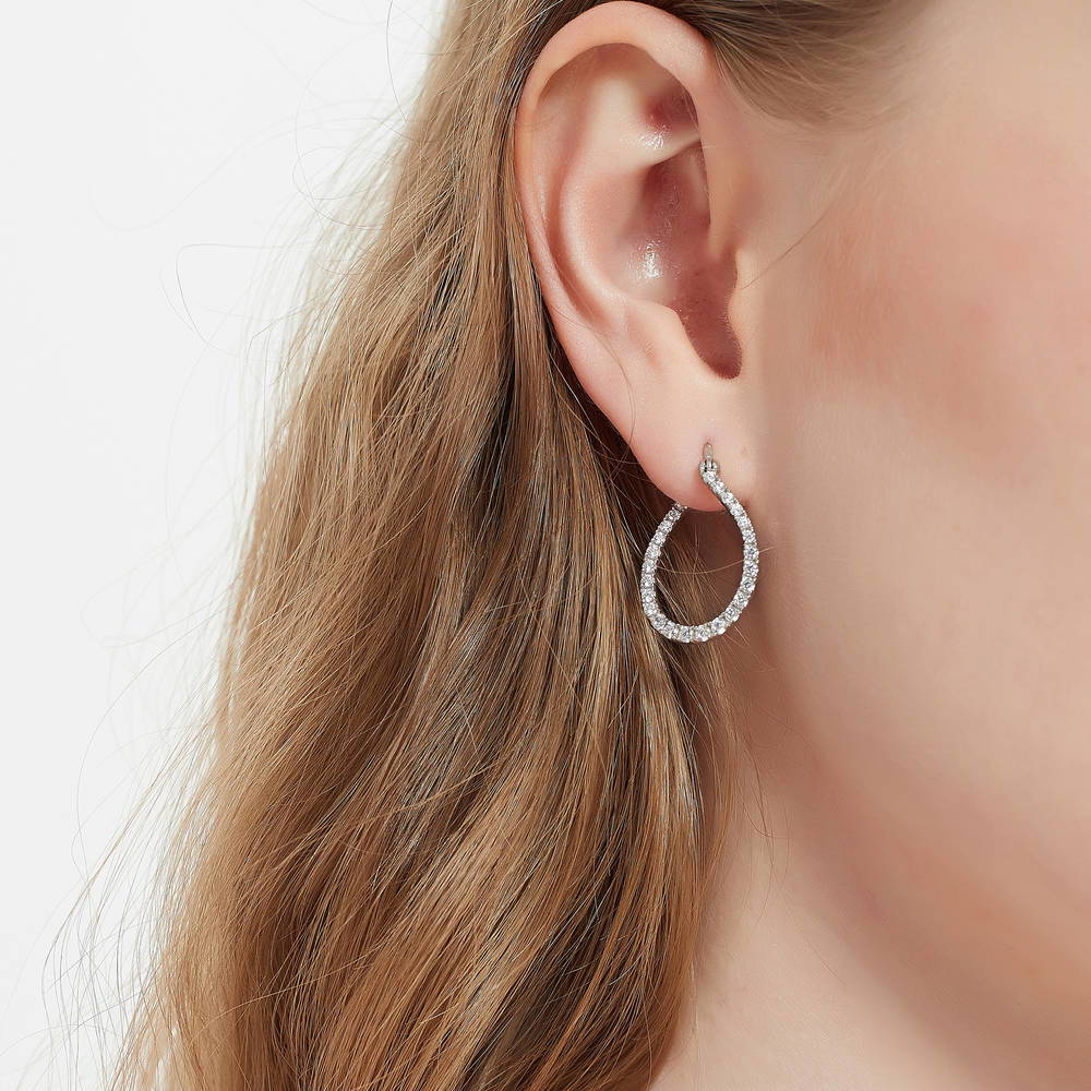 Model wearing Teardrop Woven CZ Medium Hoop Earrings in Sterling Silver 0.98 inch