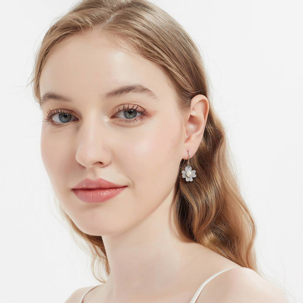Model wearing Clover Imitation Pearl Fish Hook Dangle Earrings in Sterling Silver
