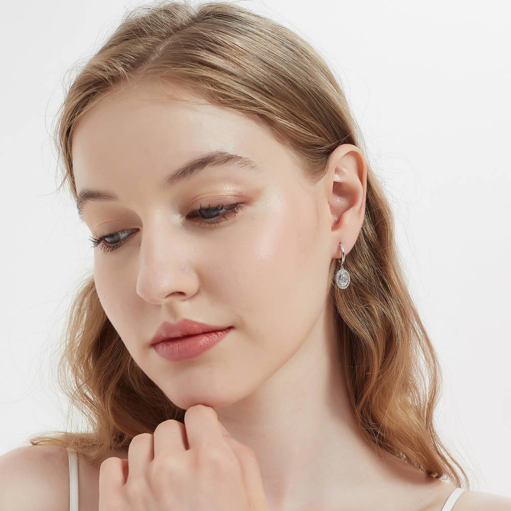 Model wearing Halo Oval CZ Dangle Earrings in Sterling Silver