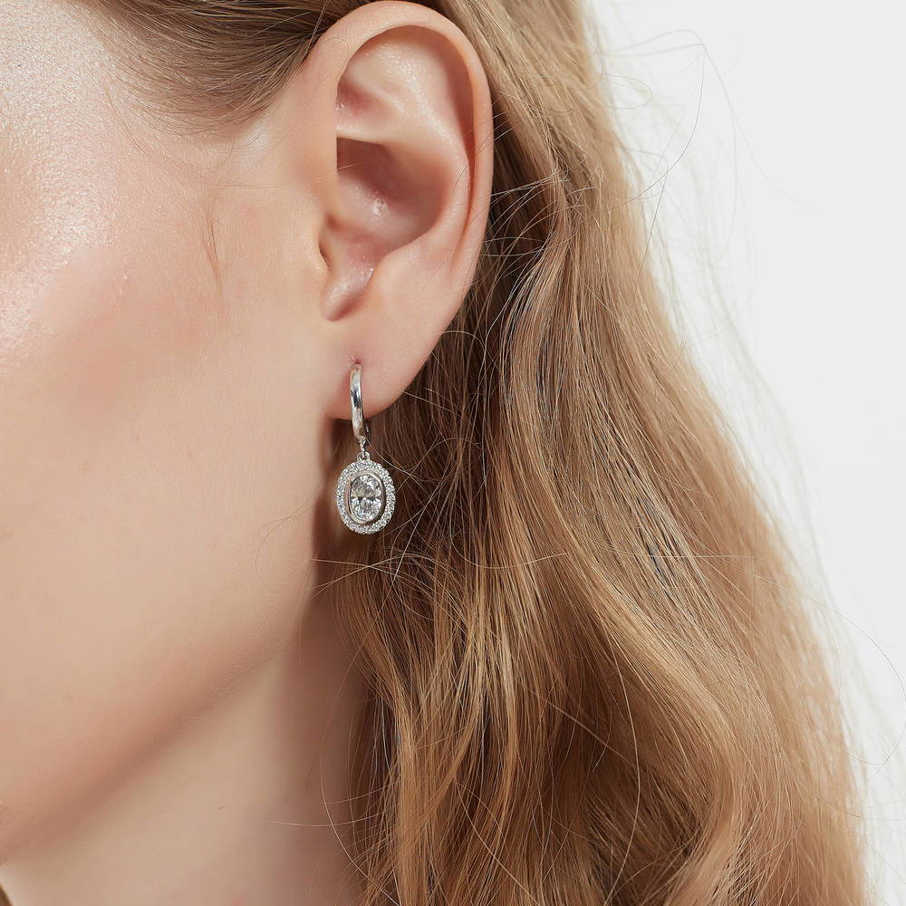 Model wearing Halo Oval CZ Dangle Earrings in Sterling Silver