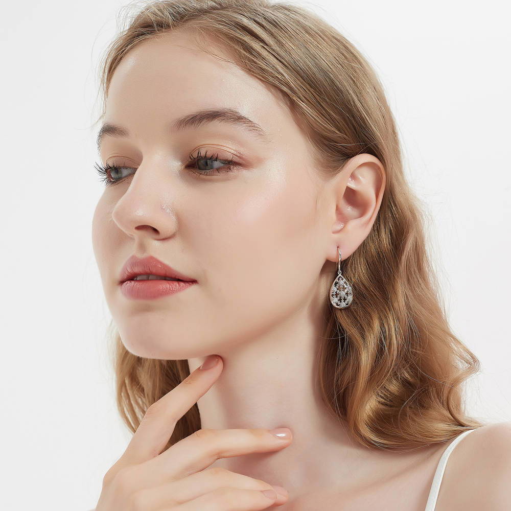 Model wearing Snowflake CZ Fish Hook Dangle Earrings in Sterling Silver
