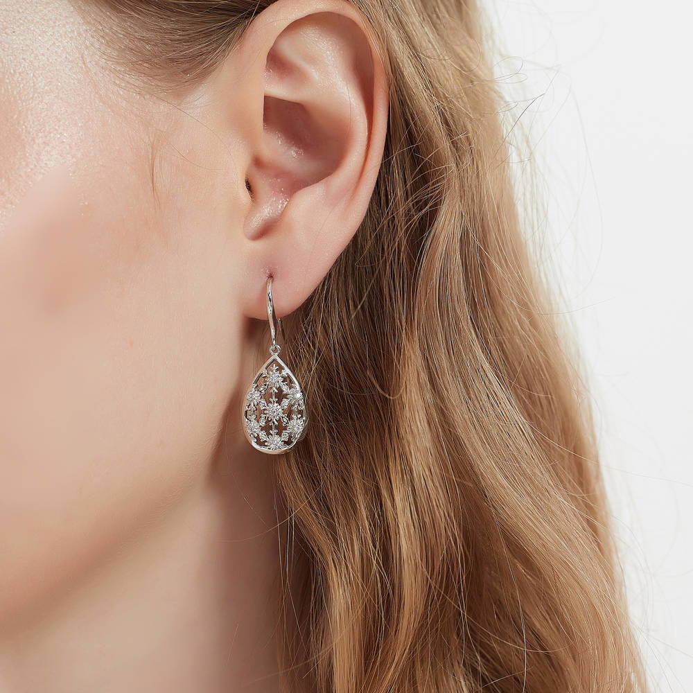 Model wearing Snowflake CZ Fish Hook Dangle Earrings in Sterling Silver