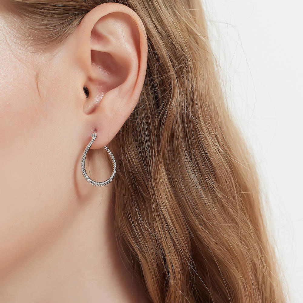 Model wearing Teardrop Woven Medium Hoop Earrings in Sterling Silver 0.95 inch