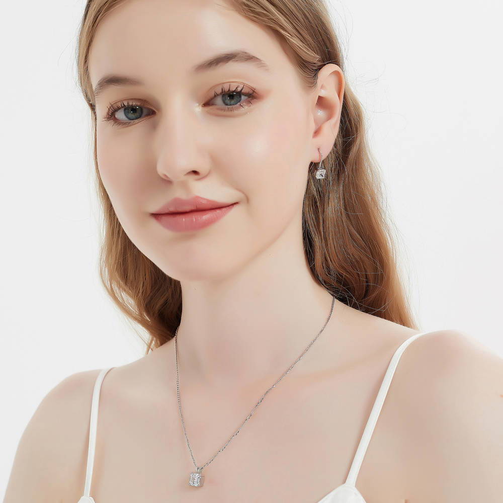 Model wearing Solitaire 3.2ct Asscher CZ Fish Hook Dangle Earrings in Sterling Silver