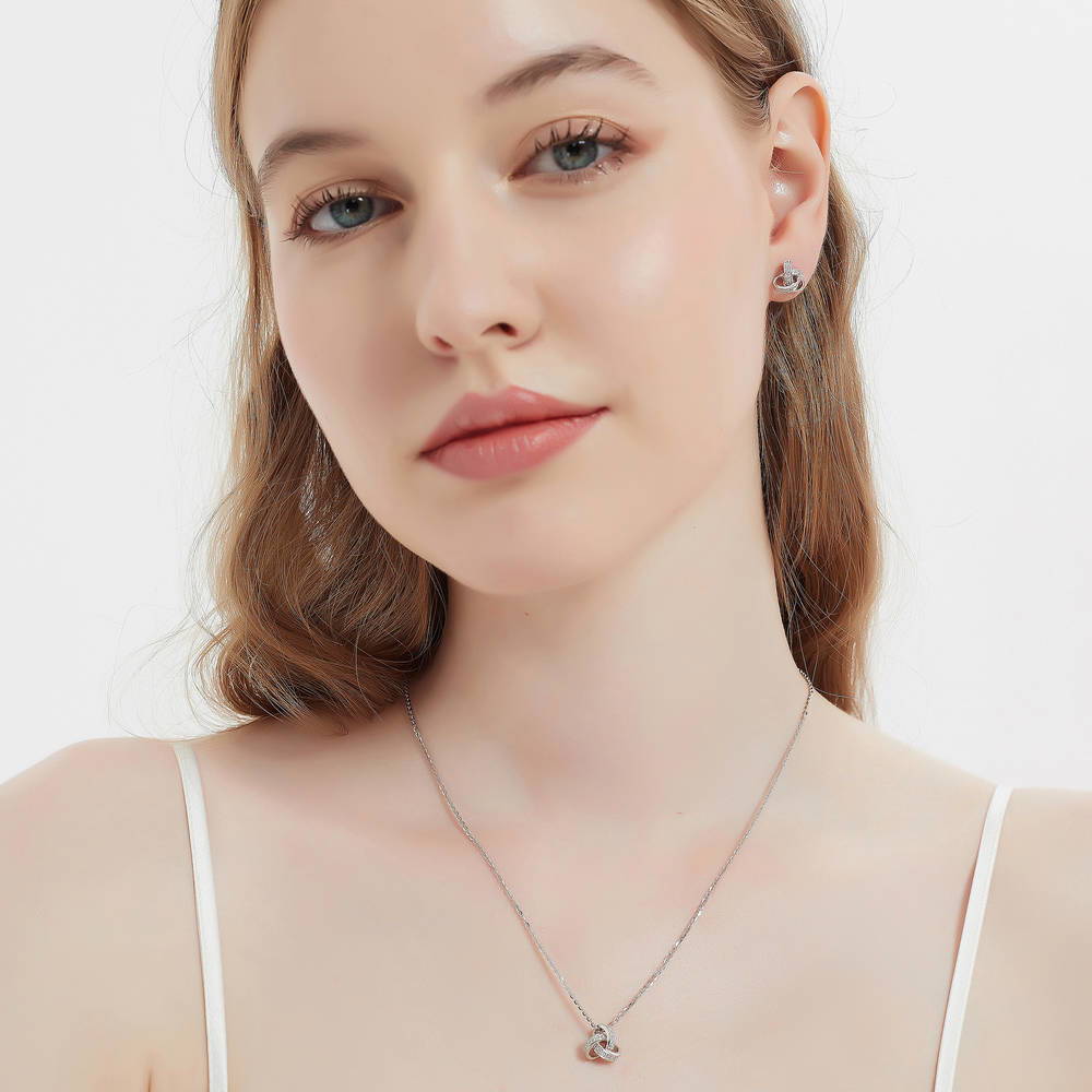 Model wearing Love Knot CZ Pendant Necklace in Sterling Silver, 7 of 9