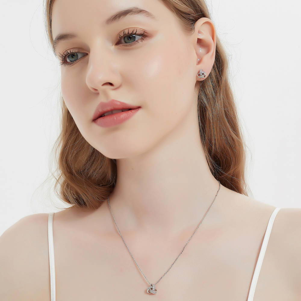 Model wearing Love Knot CZ Necklace and Earrings Set in Sterling Silver
