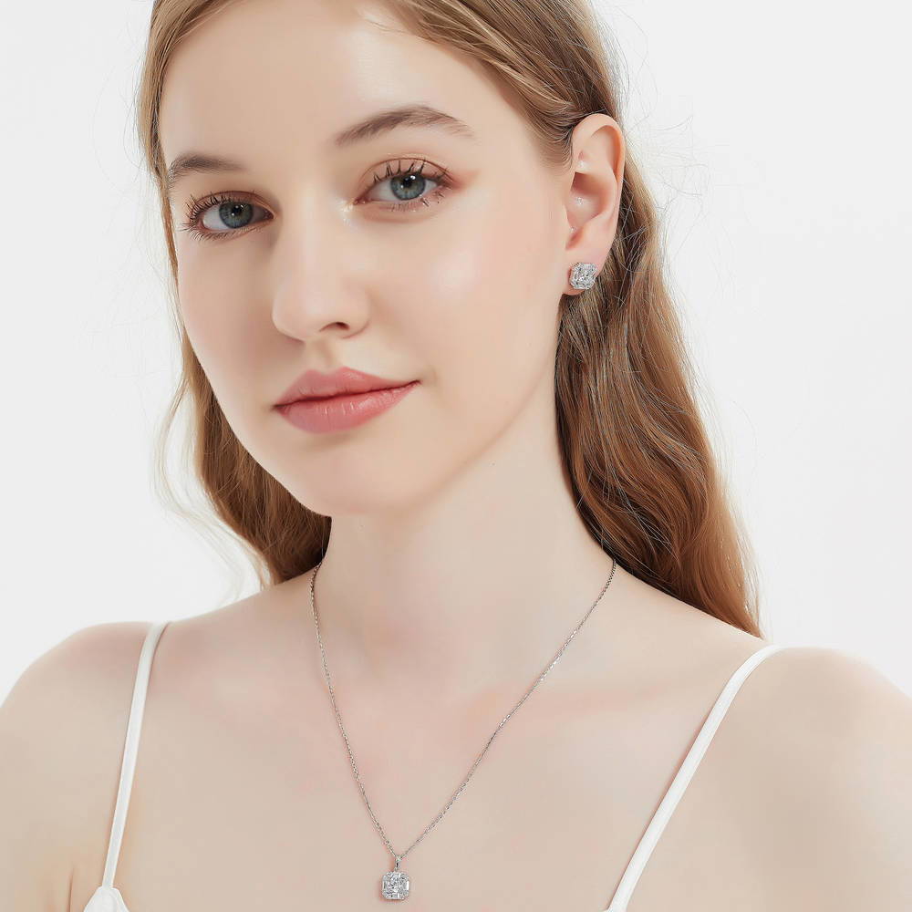 Model wearing Halo Art Deco Round CZ Stud Earrings in Sterling Silver