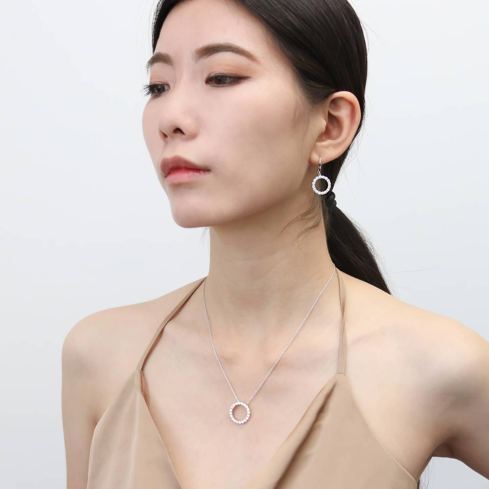 Model wearing Open Circle CZ Fish Hook Dangle Earrings in Sterling Silver