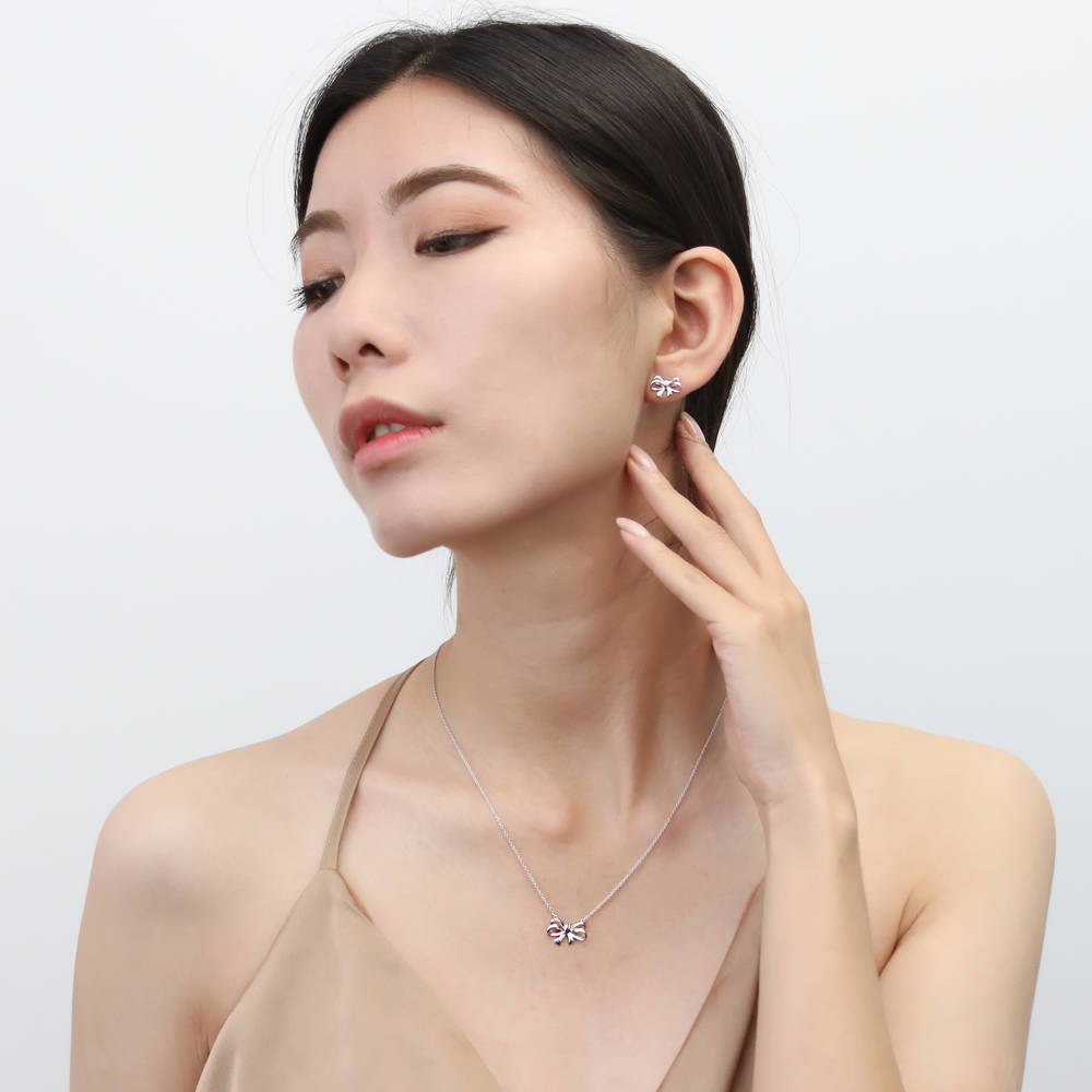 Model wearing Bow Tie Ribbon CZ Necklace in Sterling Silver, Style 1