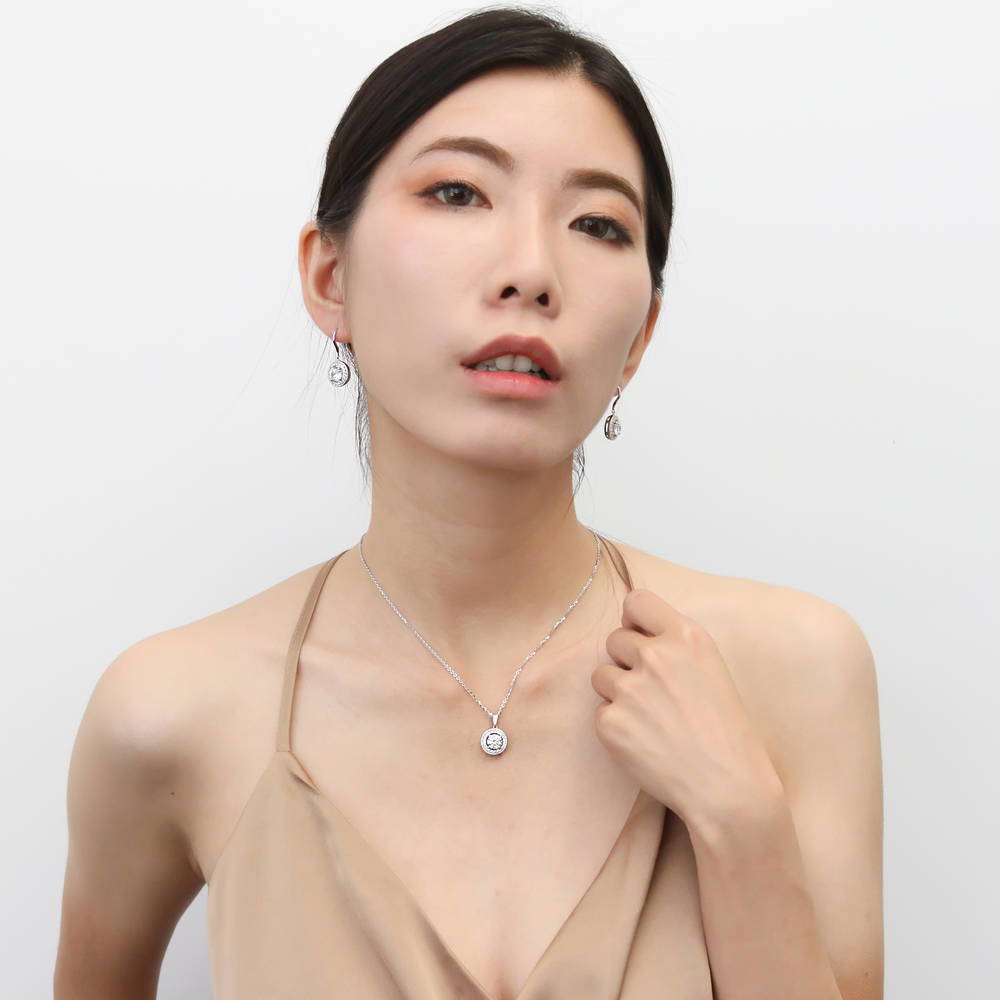 Model wearing Halo Cable Round CZ Fish Hook Dangle Earrings in Sterling Silver