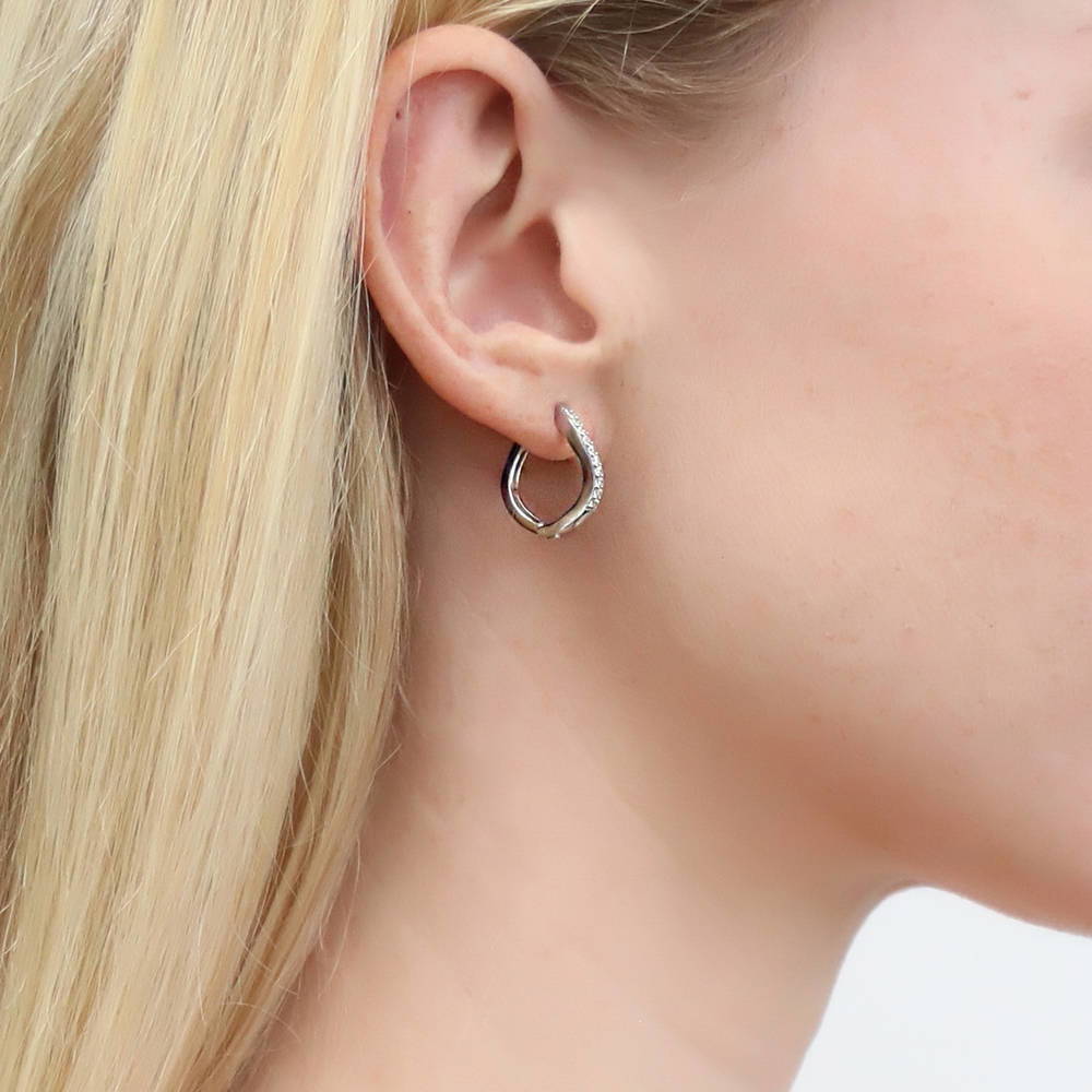 Model wearing Wave Woven CZ Medium Hoop Earrings in Sterling Silver 0.72 inch