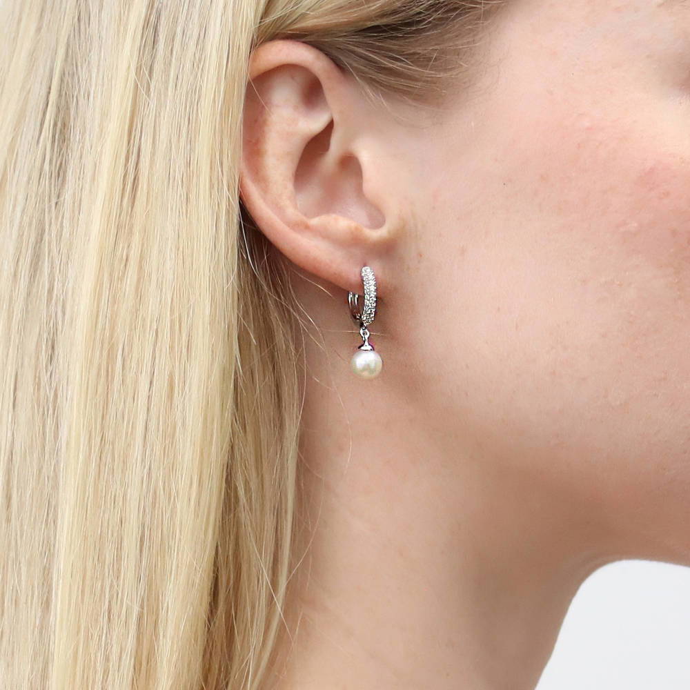 Model wearing Solitaire White Round Cultured Pearl Earrings in Sterling Silver