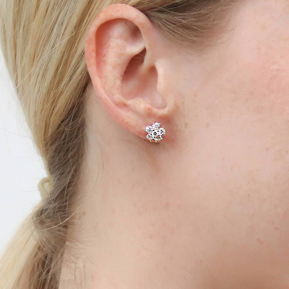 Model wearing Flower CZ Stud Earrings in Sterling Silver