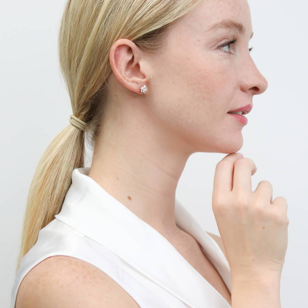 Model wearing Flower CZ Stud Earrings in Sterling Silver