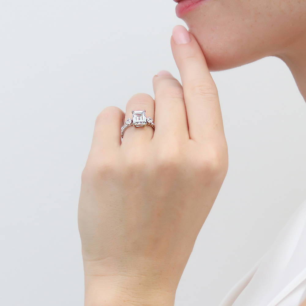 Model wearing 3-Stone Woven Emerald Cut CZ Ring in Sterling Silver