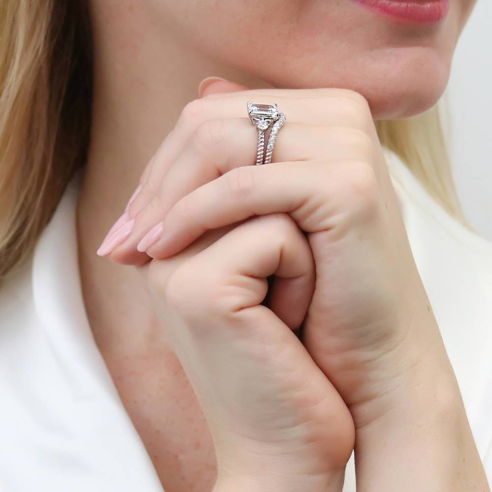 Model wearing 3-Stone Woven Emerald Cut CZ Ring Set in Sterling Silver