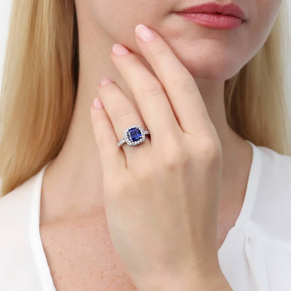 Model wearing Halo Simulated Blue Sapphire Cushion CZ Ring in Sterling Silver