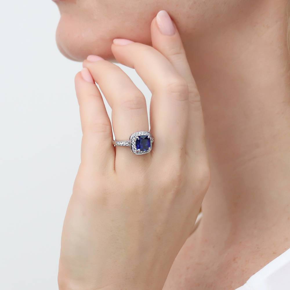 Model wearing Halo Simulated Blue Sapphire Cushion CZ Ring in Sterling Silver