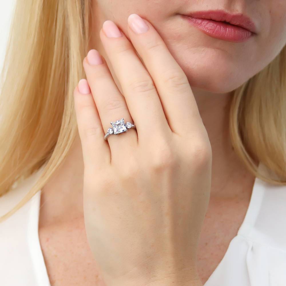 Model wearing 3-Stone Woven Princess CZ Ring in Sterling Silver
