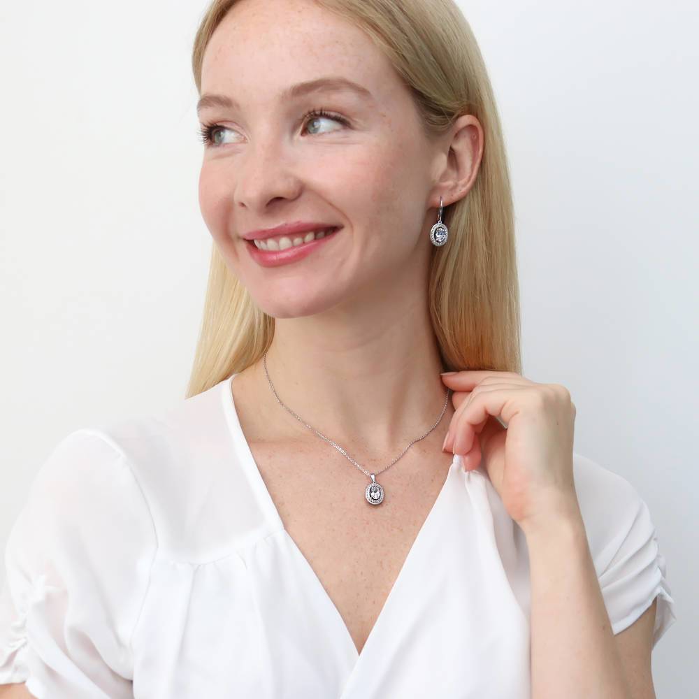 Model wearing Halo Woven Oval CZ Fish Hook Dangle Earrings in Sterling Silver