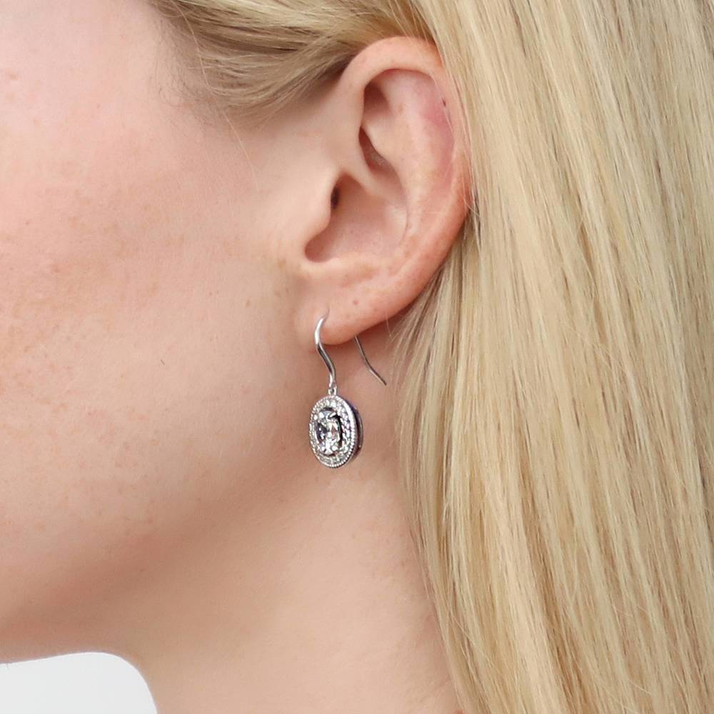 Model wearing Halo Woven Oval CZ Fish Hook Dangle Earrings in Sterling Silver