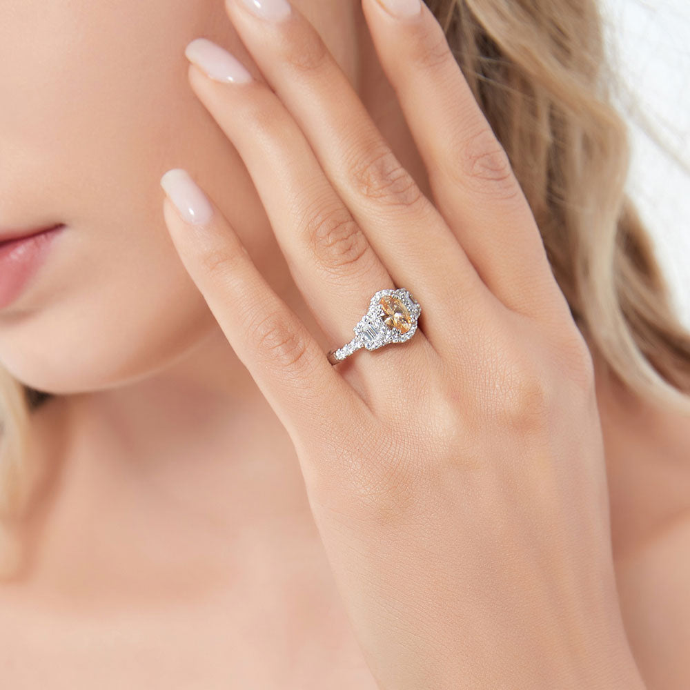 Model wearing 3-Stone Halo Yellow Oval CZ Ring in Sterling Silver