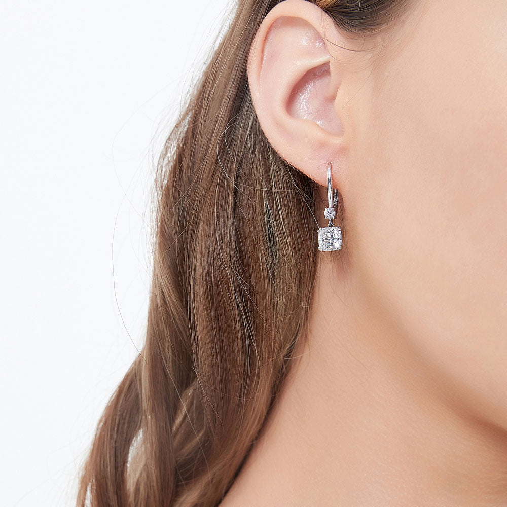 Model wearing Solitaire 4ct Cushion CZ Leverback Dangle Earrings in Sterling Silver, 2 of 5