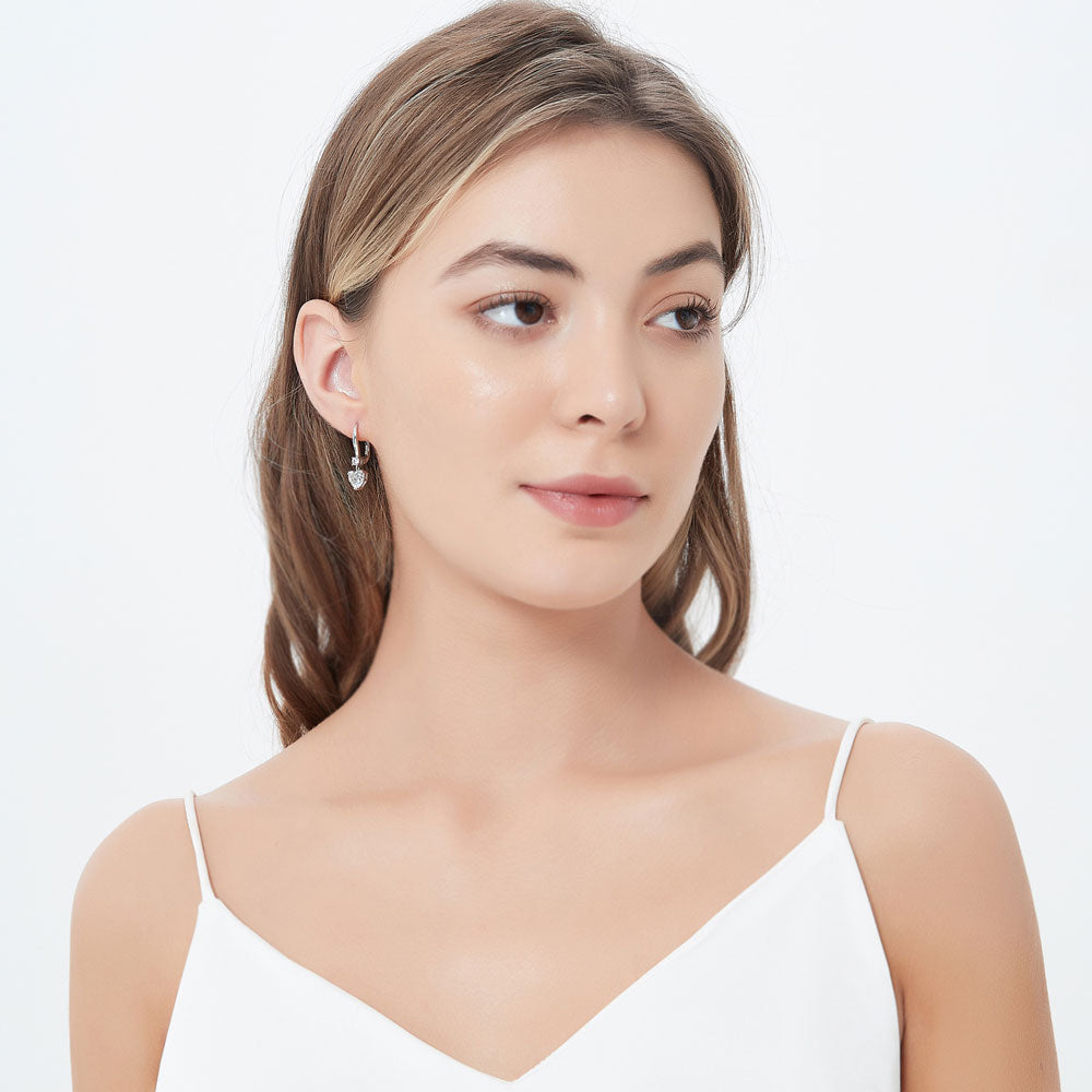 Model wearing Solitaire 2.2ct Heart CZ Leverback Dangle Earrings in Sterling Silver