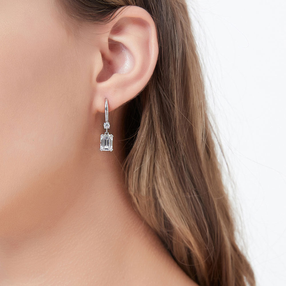 Model wearing Solitaire 3.4ct Emerald Cut CZ Leverback Earrings in Sterling Silver