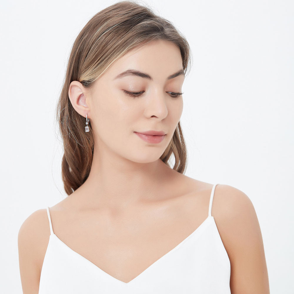 Model wearing Solitaire 3.2ct Cushion CZ Leverback Dangle Earrings in Sterling Silver