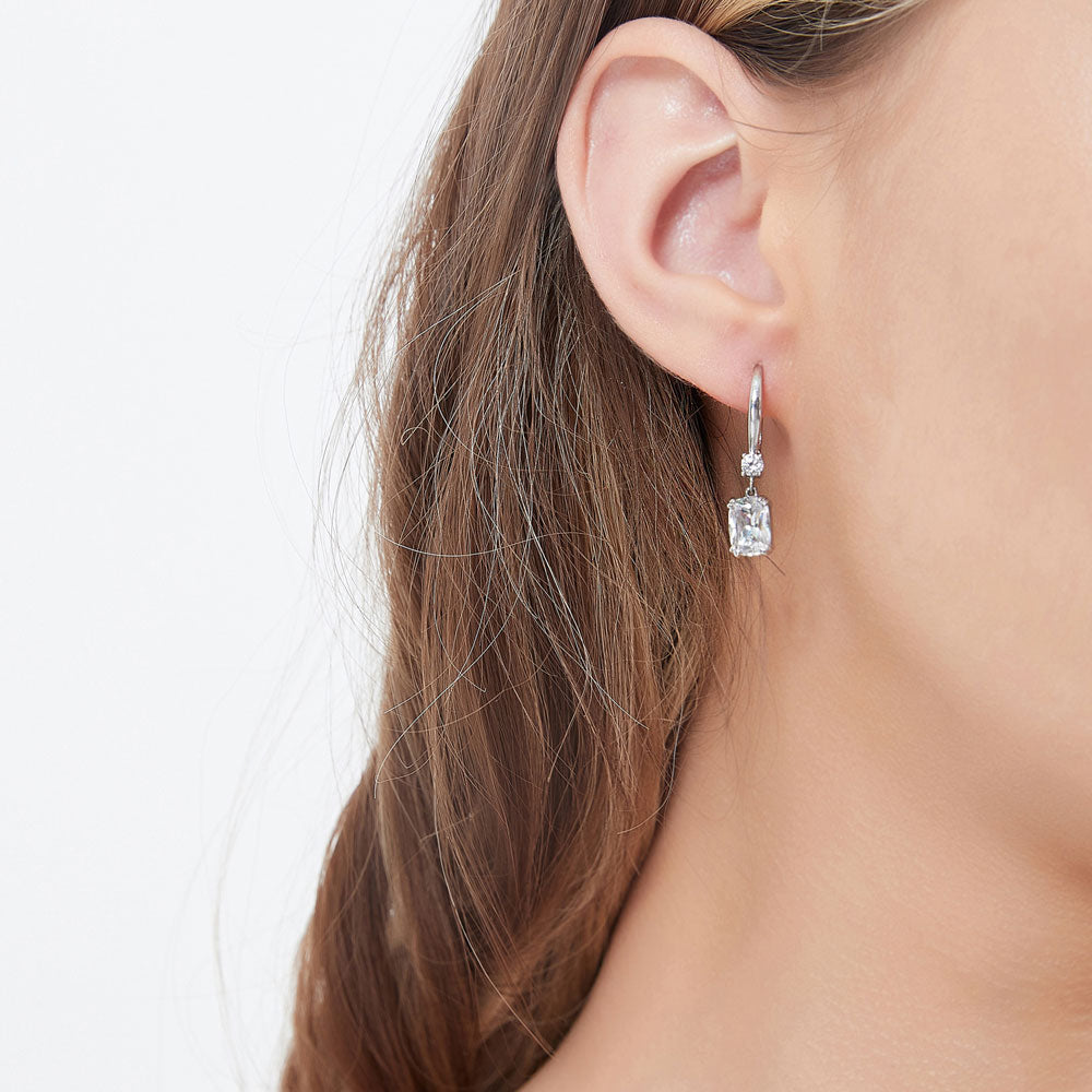 Model wearing Solitaire 3.2ct Cushion CZ Leverback Dangle Earrings in Sterling Silver