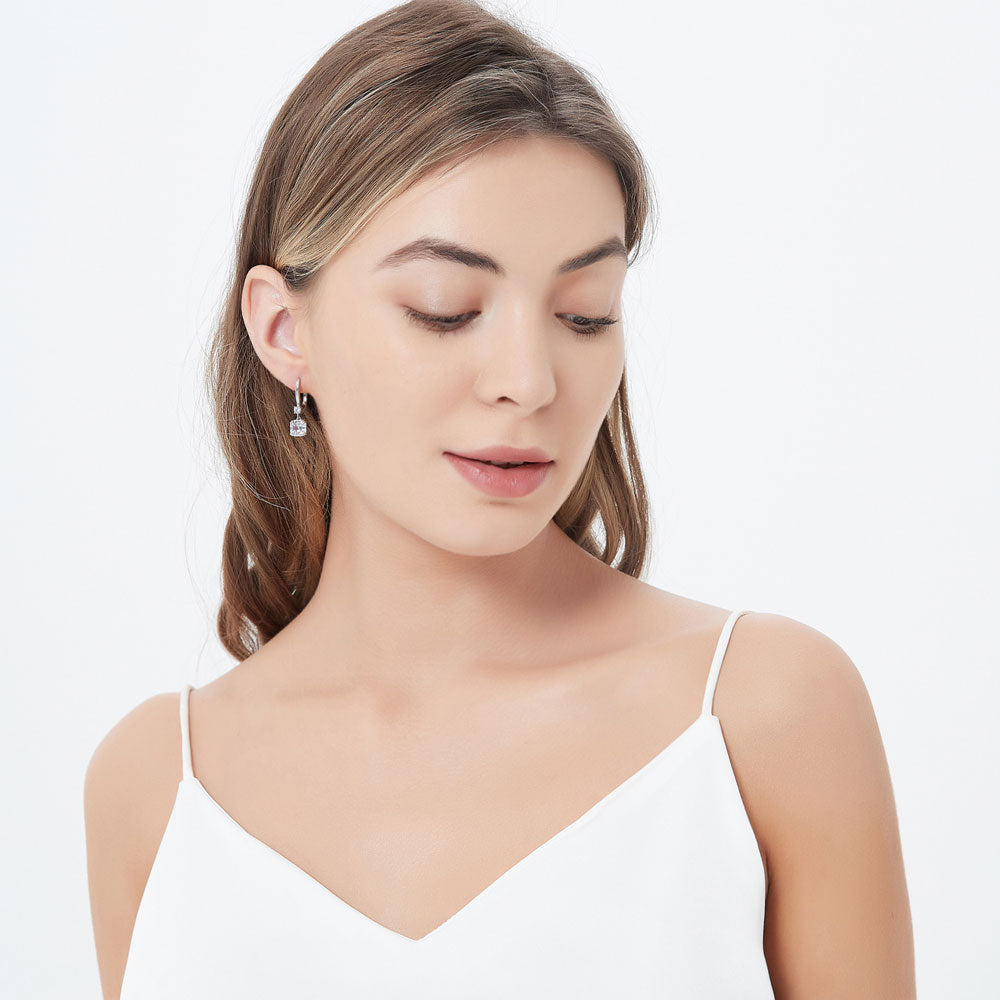 Model wearing Solitaire 4ct Asscher CZ Leverback Dangle Earrings in Sterling Silver