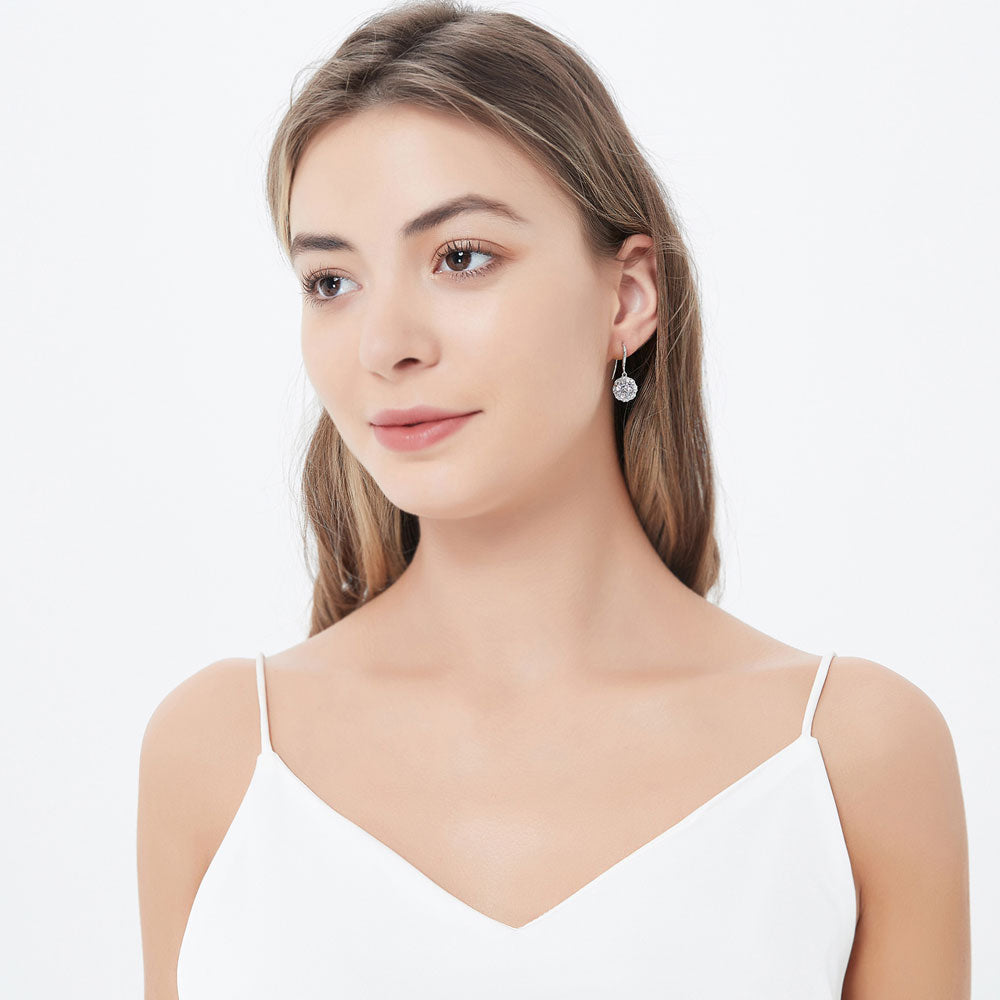 Model wearing Halo Art Deco Round CZ Fish Hook Dangle Earrings in Sterling Silver