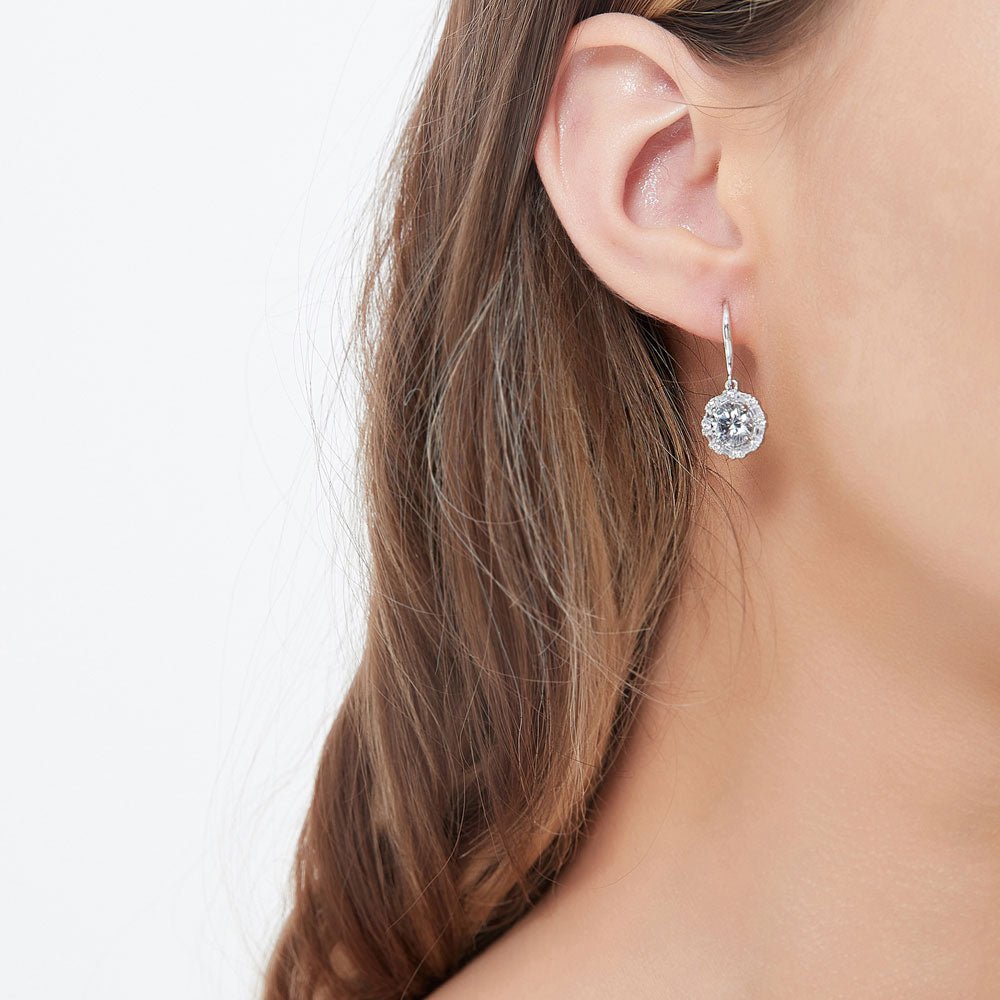 Model wearing Halo Art Deco Round CZ Fish Hook Dangle Earrings in Sterling Silver