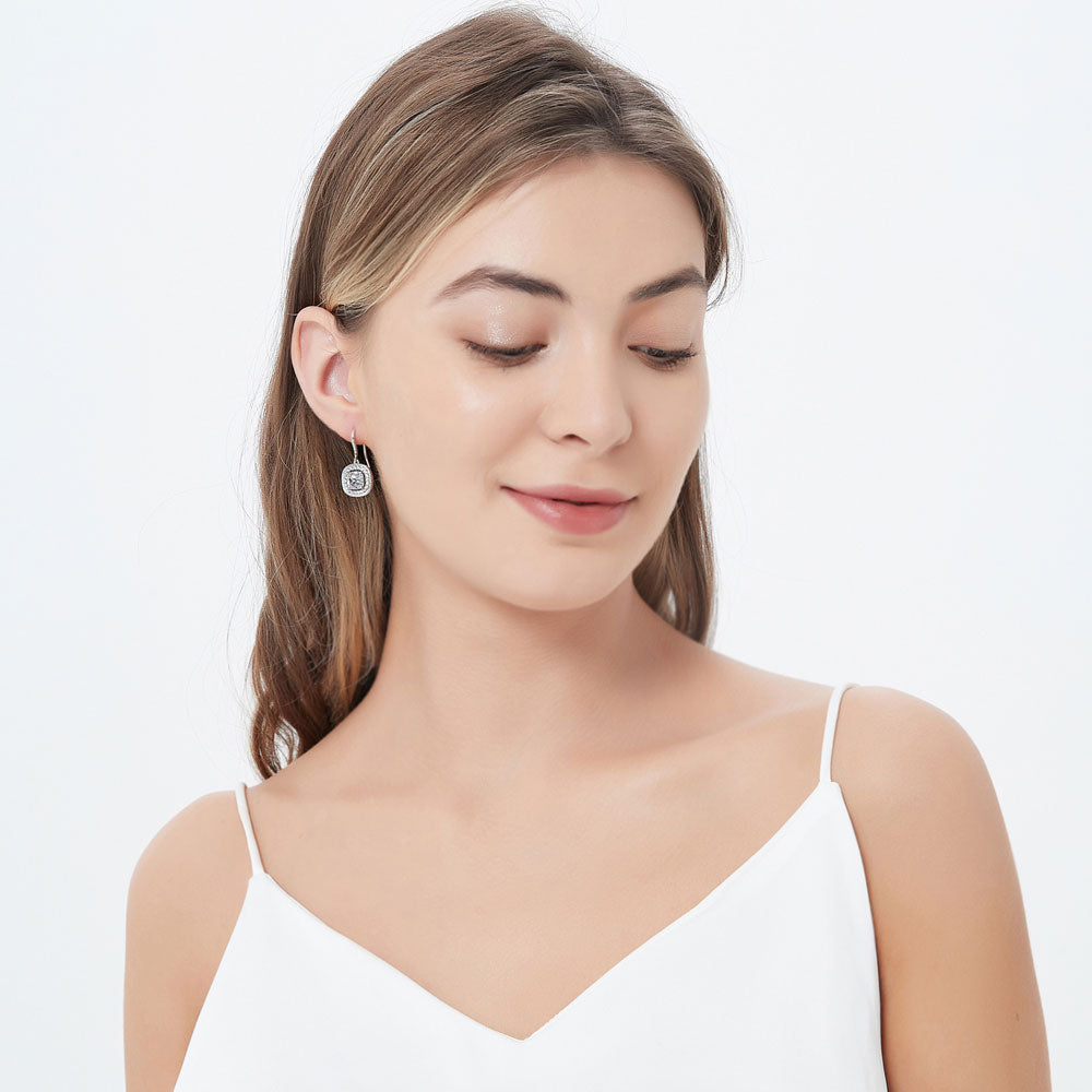 Model wearing Halo Woven Cushion CZ Fish Hook Dangle Earrings in Sterling Silver