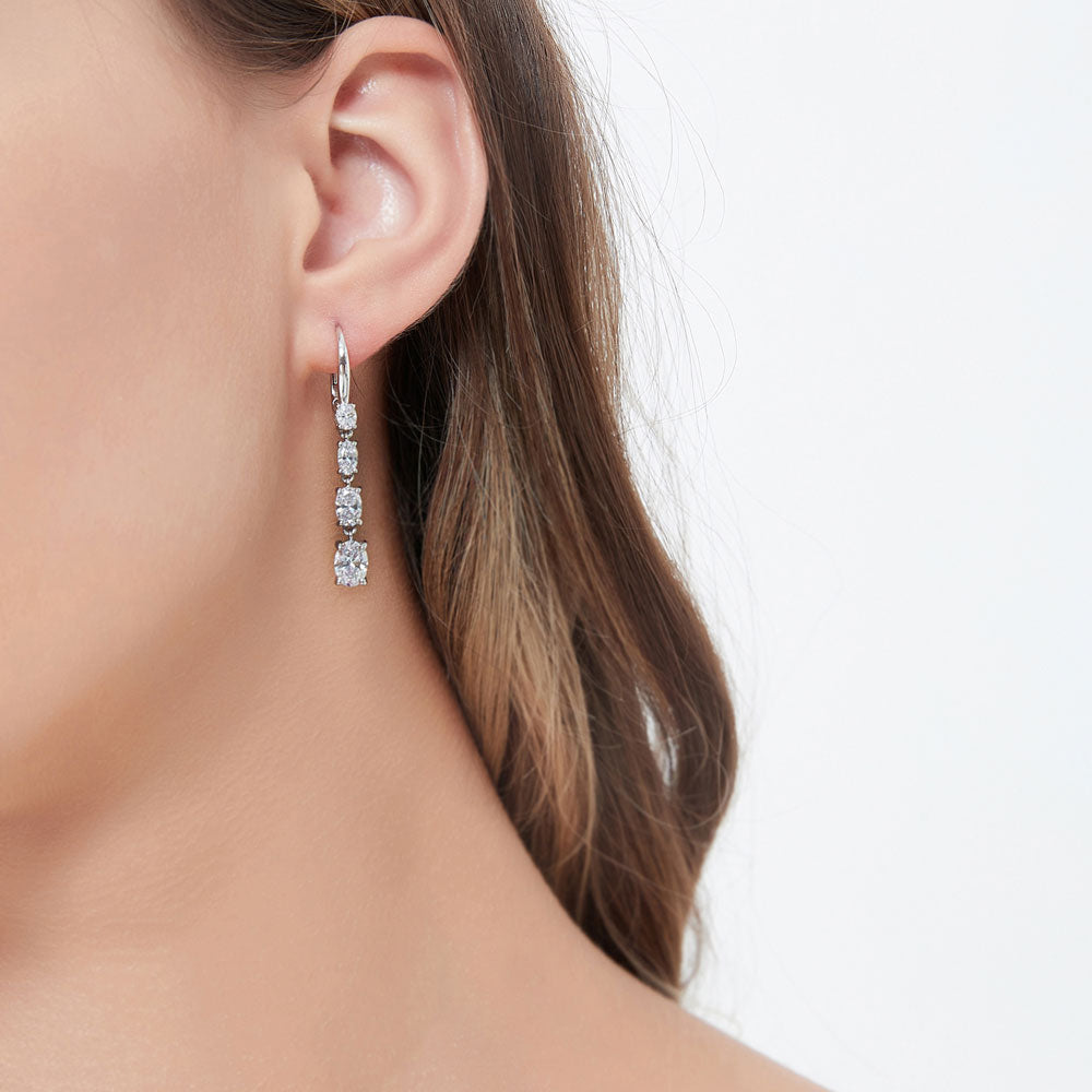 Model wearing Graduated CZ Leverback Dangle Earrings in Sterling Silver