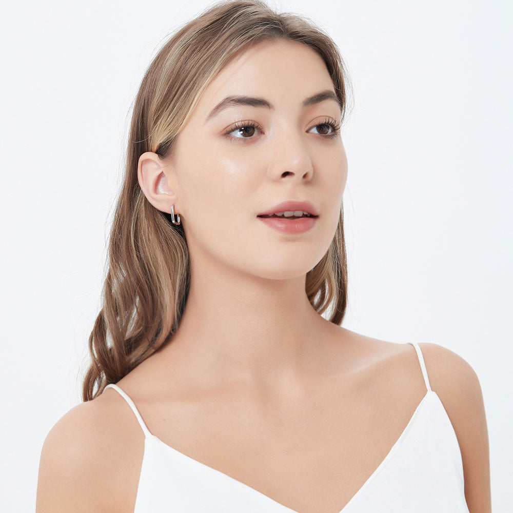 Model wearing Rectangle Medium Hoop Earrings in Sterling Silver 0.6 inch