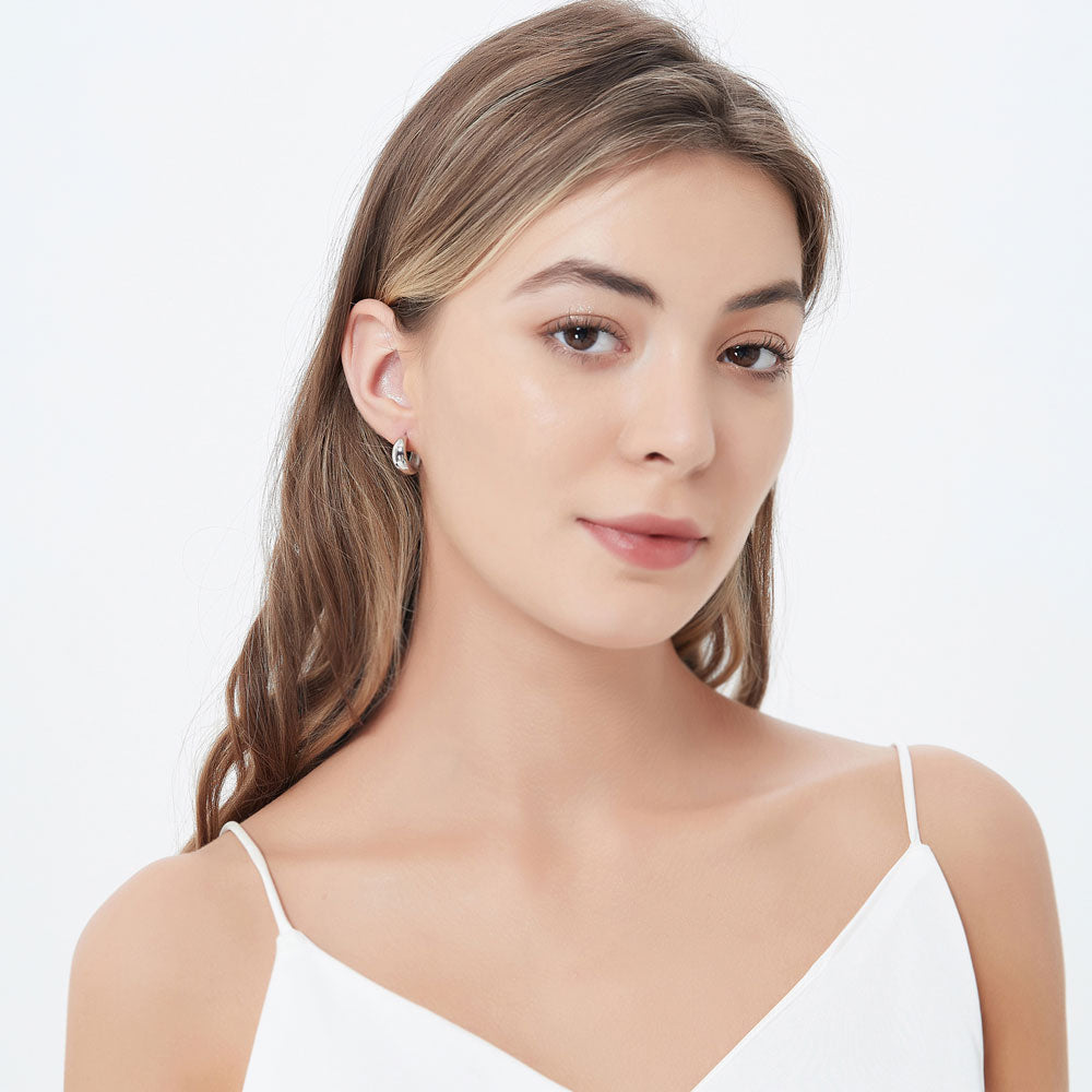 Model wearing Dome Medium Half Hoop Earrings in Sterling Silver 0.6 inch, 3 of 4