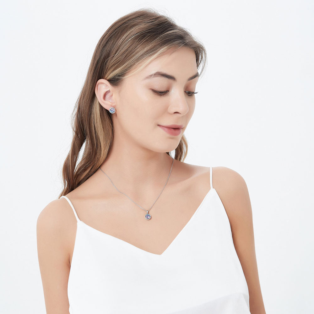 Model wearing Solitaire Purple Aqua Round CZ Stud Earrings in Sterling Silver 2.5ct