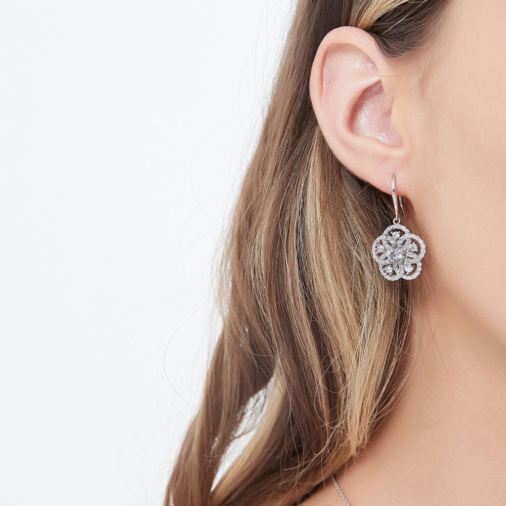 Model wearing Flower CZ Statement Fish Hook Dangle Earrings in Sterling Silver