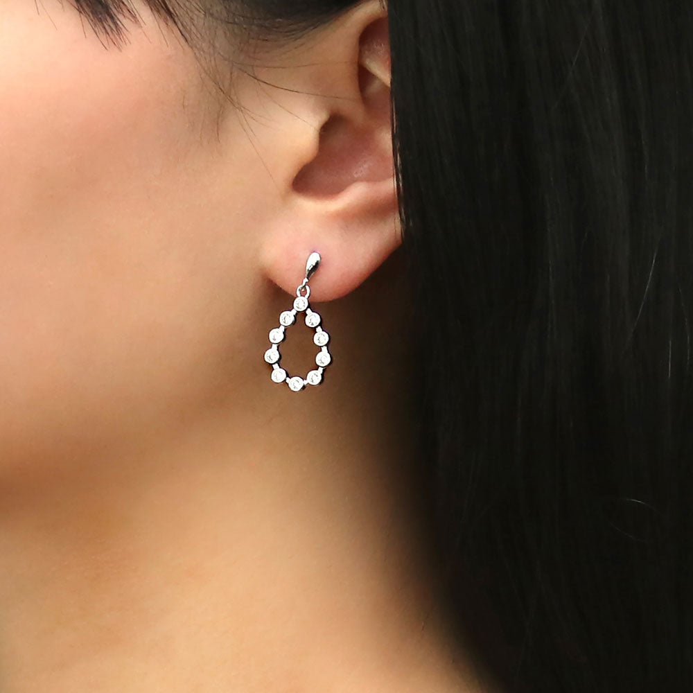 Model wearing Bubble Teardrop CZ Dangle Earrings in Sterling Silver