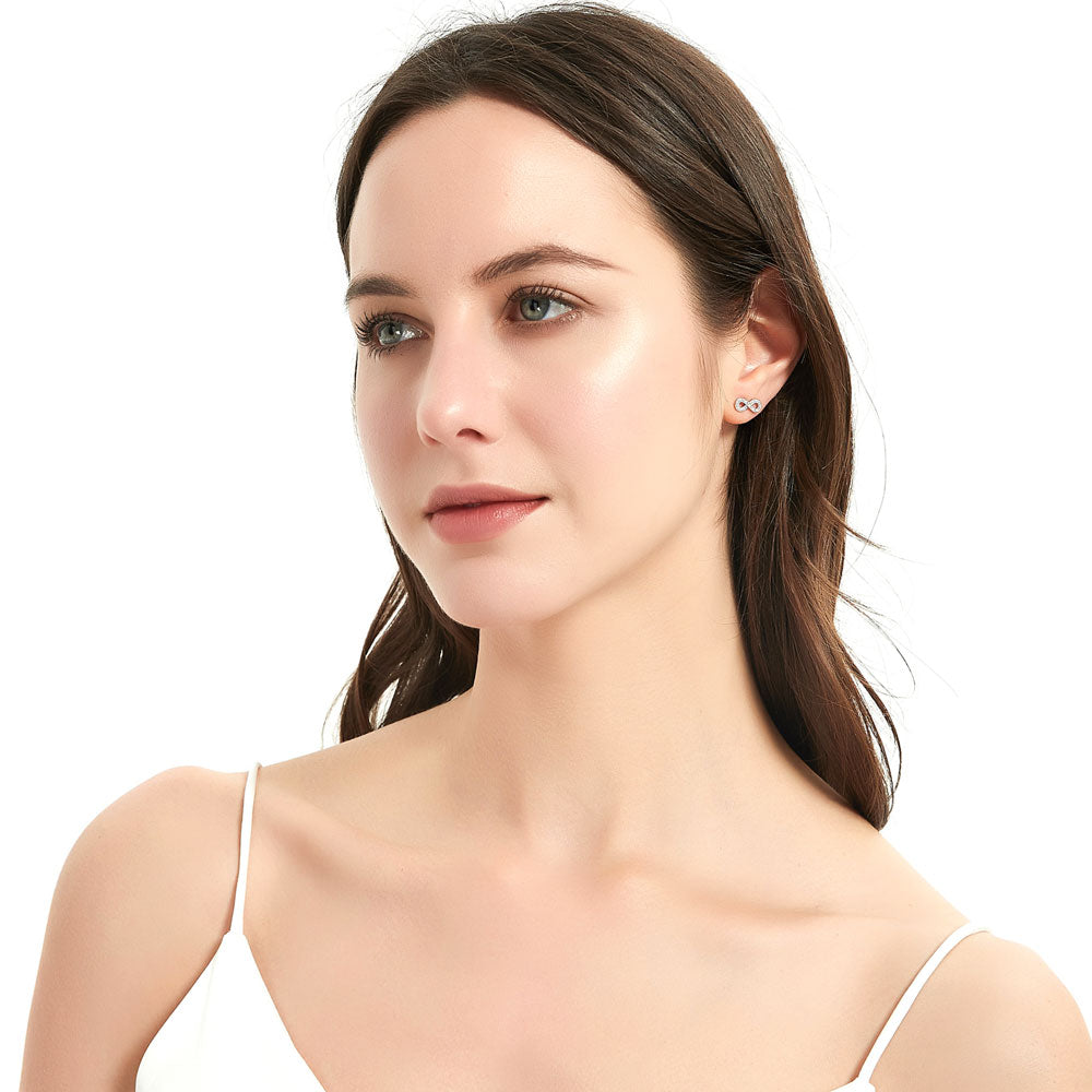 Model wearing Infinity CZ Stud Earrings in Sterling Silver