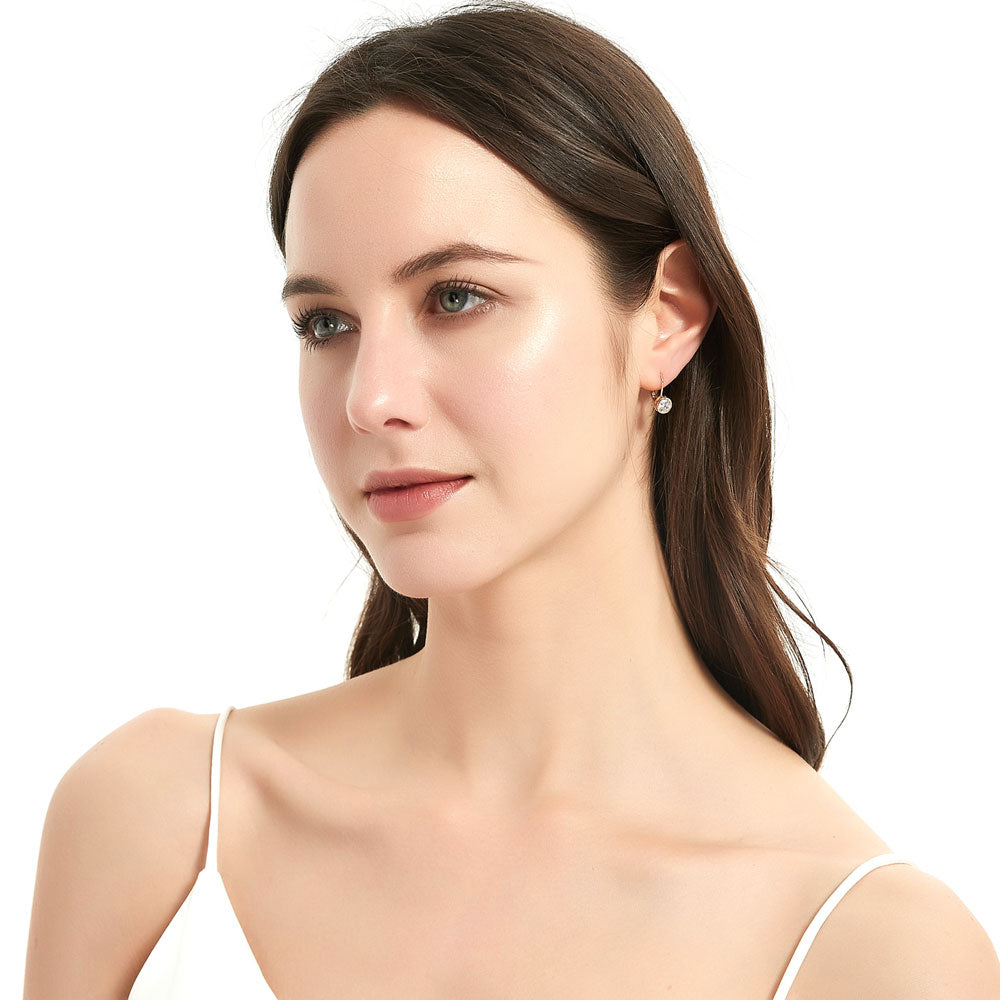 Model wearing Solitaire 1.2ct Bezel Set Round CZ Dangle Earrings in Sterling Silver