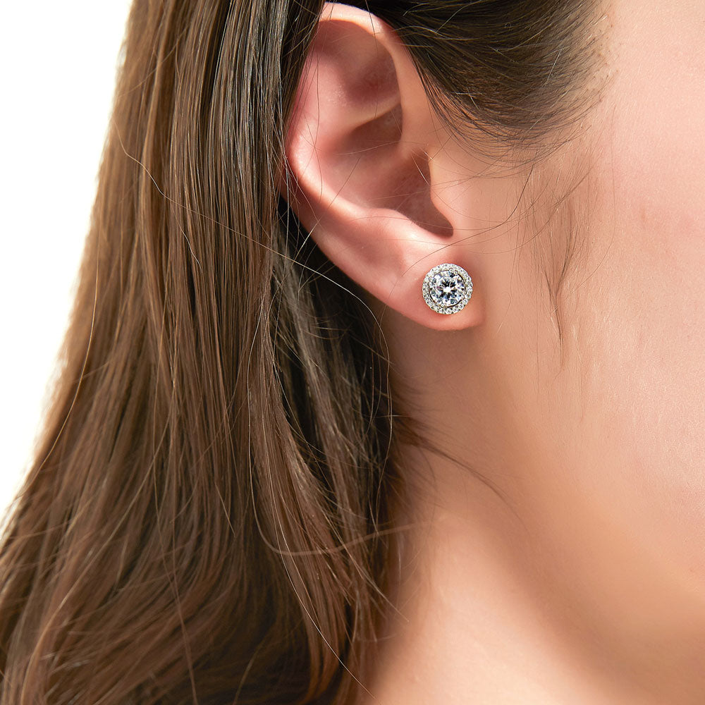 Model wearing Halo Solitaire Round CZ Stud Earrings in Sterling Silver, 2 Pairs