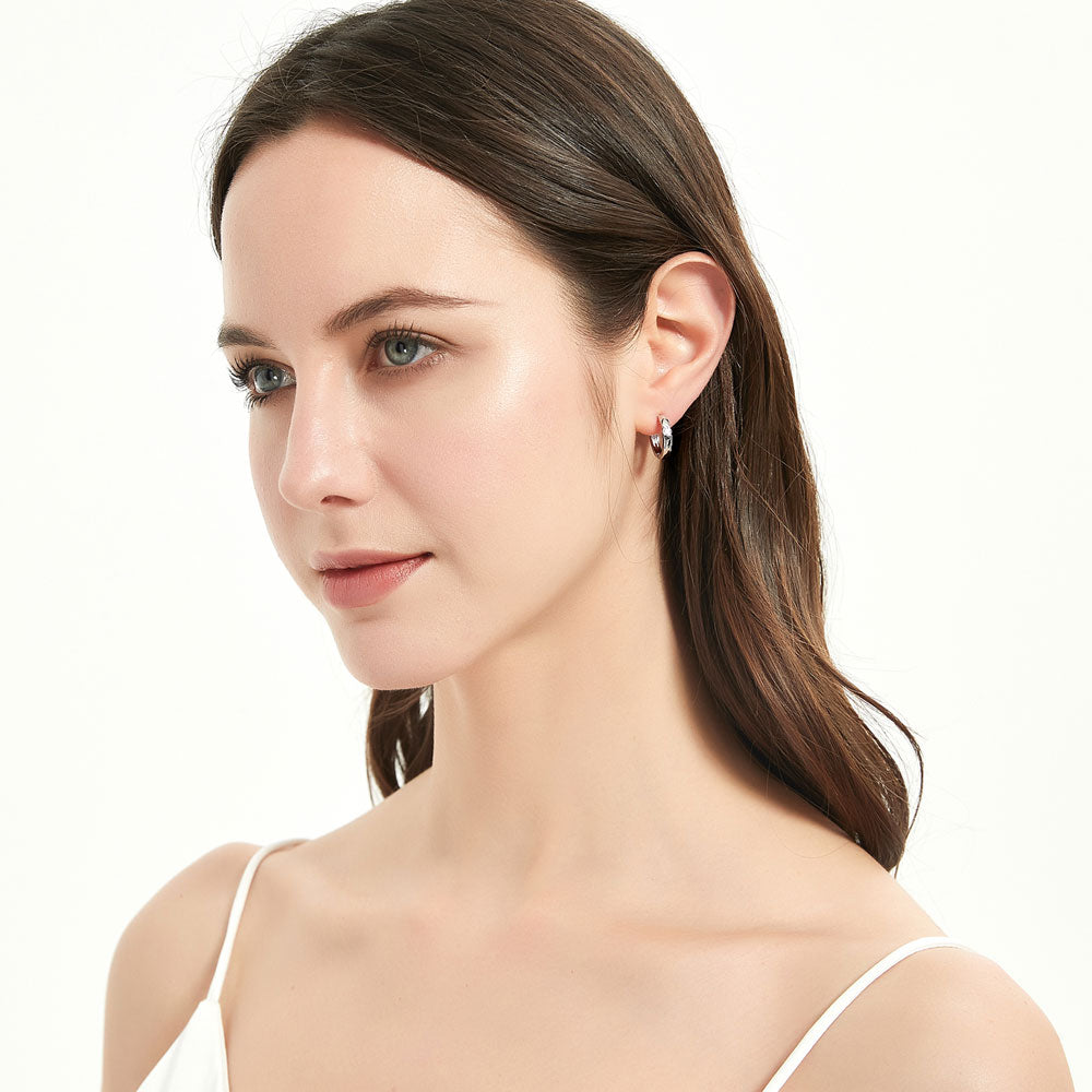 Model wearing Solitaire Round CZ Medium Hoop Earrings in Sterling Silver 0.22ct 0.64 inch, 7 of 10